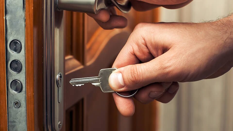 Emergency Locksmith unlocking a locked door using professional lock opening tools