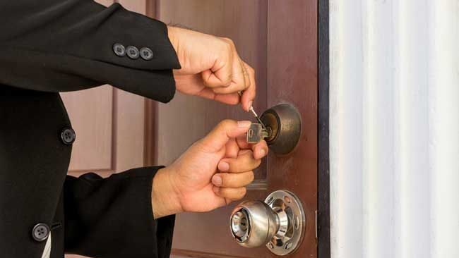 Professional locksmith opening a locked house door without causing damage in Boston, MA.